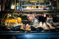 Senior man in his shoe repair shop