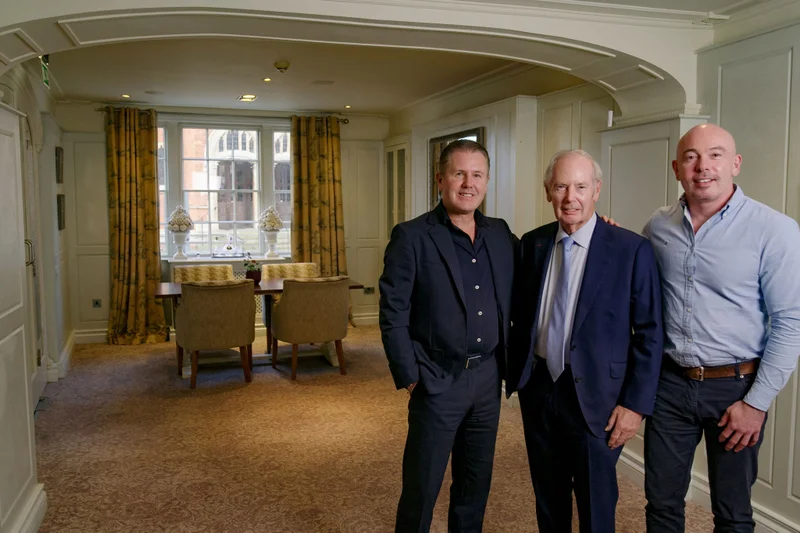 A portrait of James Rigby, Sir Peter Rigby and Steve Rigby in a hotel